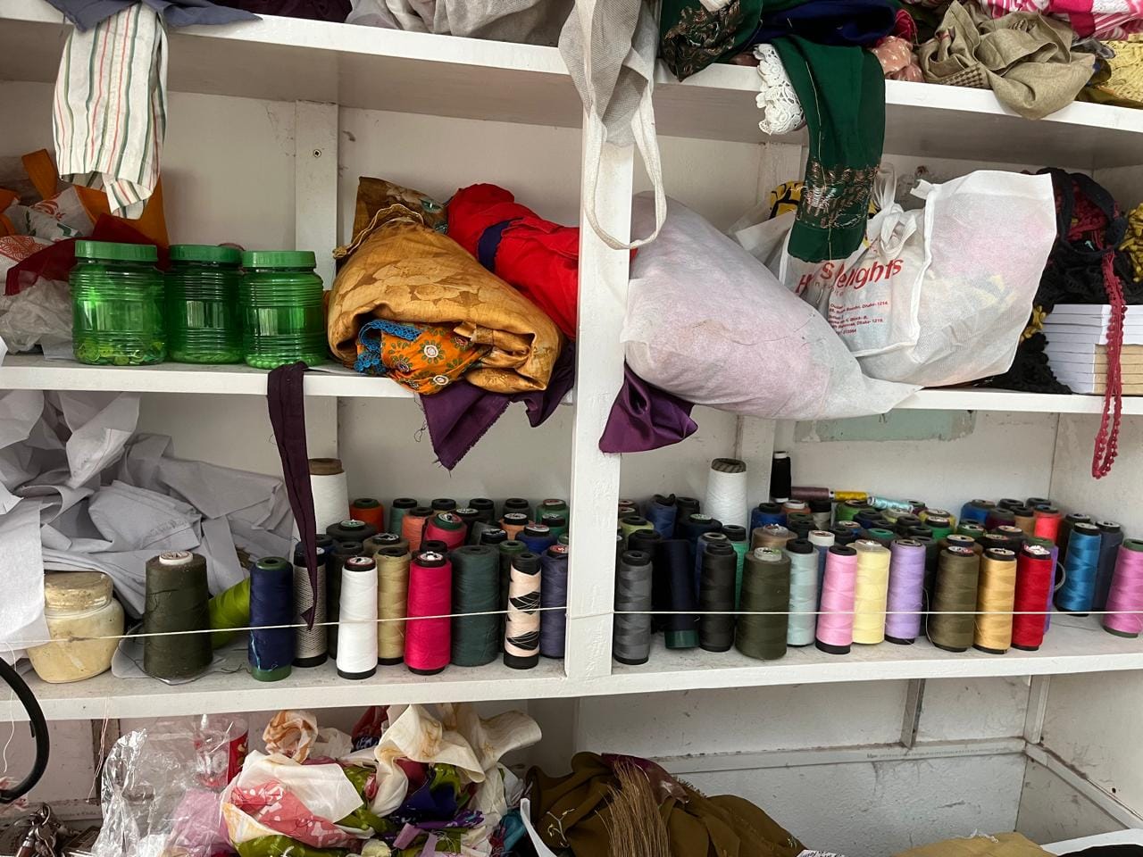 Organized garment thread spools, trims, and raw material inventory storage at Simon Morsh Boutique House
